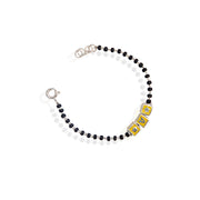 A kids' bracelet made of sterling silver with a golden color, featuring alphabet blocks as the design.